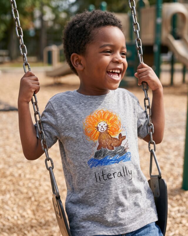 A boy on a swing in the literally sea lion t-shirt