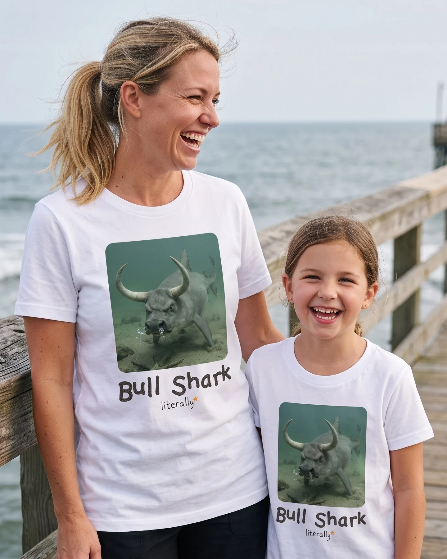 Mom and daughter on a pier wearing matching literally Bull Shark photo t-shirts